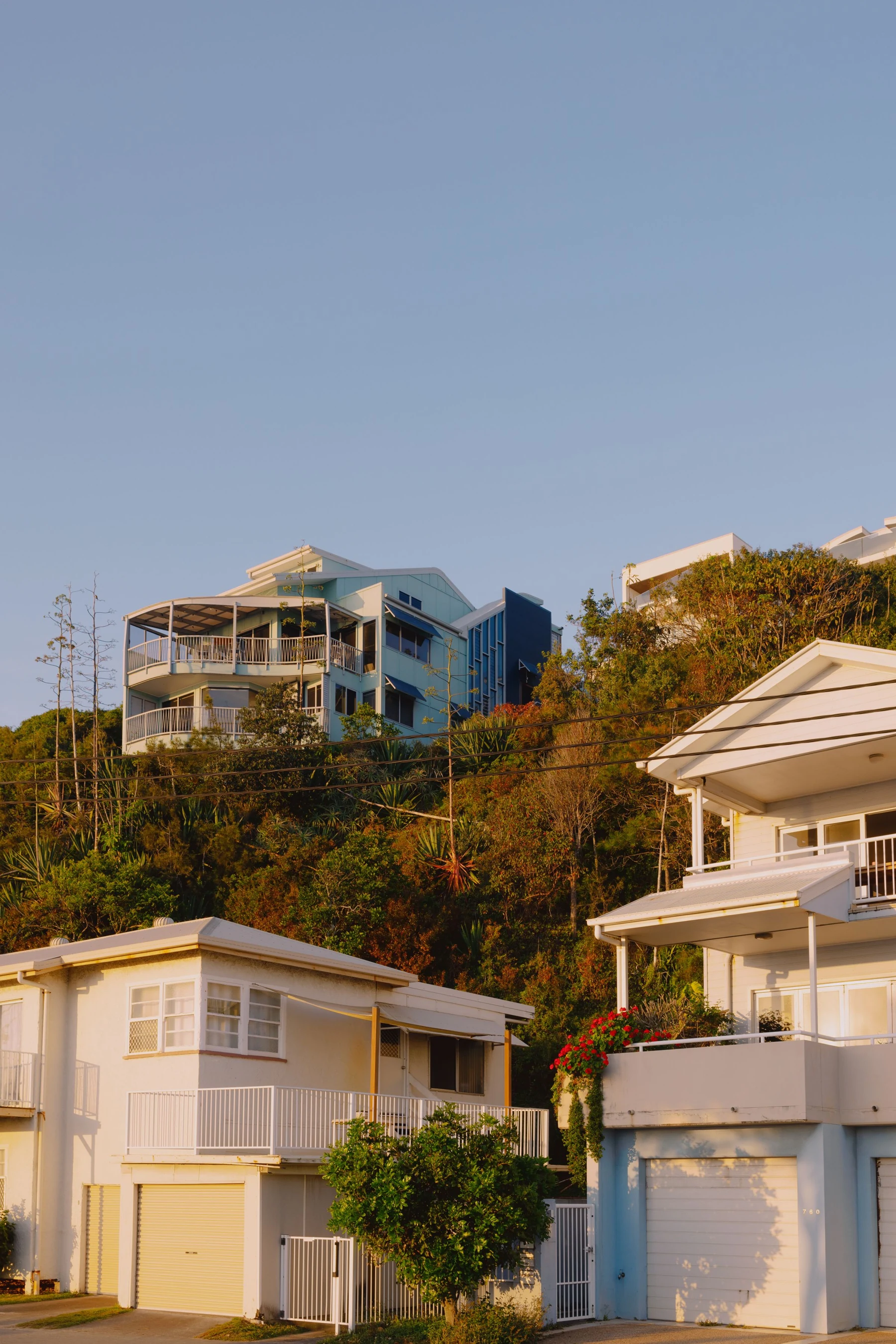 Hillside homes in warm afternoon light in Currumbin, Queensland