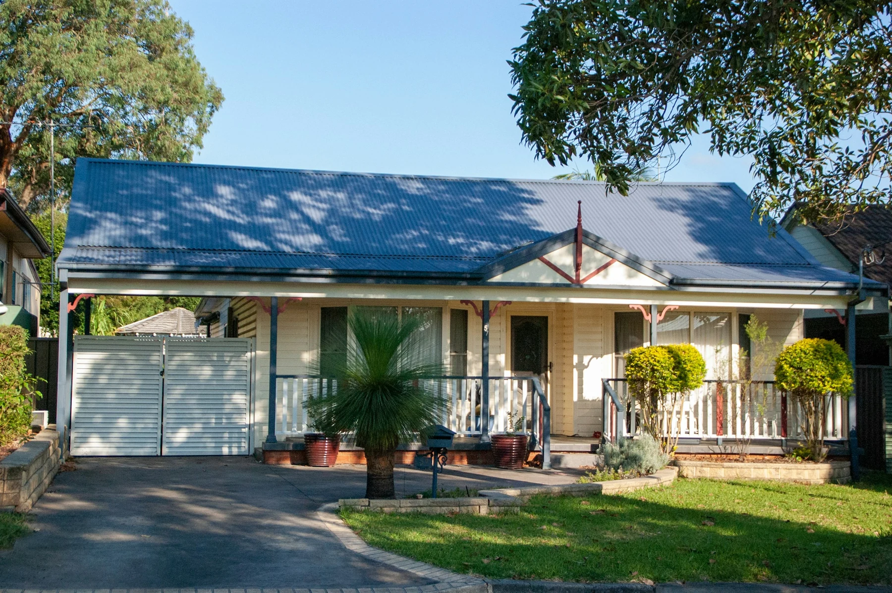 A cottage with a front verandah and garden in Revesby, New South Wales